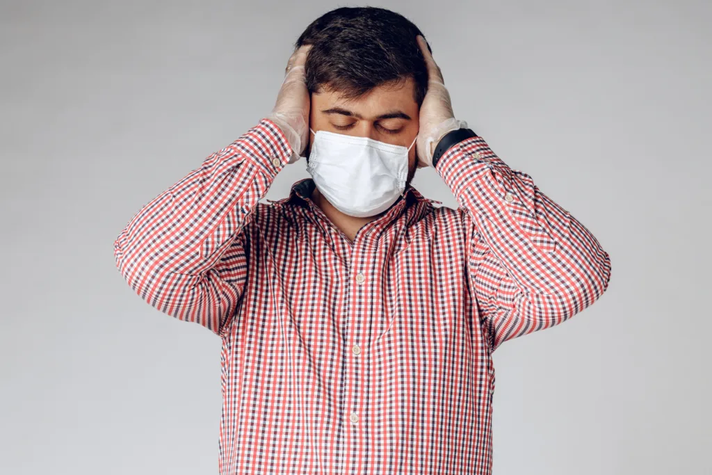 sick man medical mask face protective gloves hands feeling headache